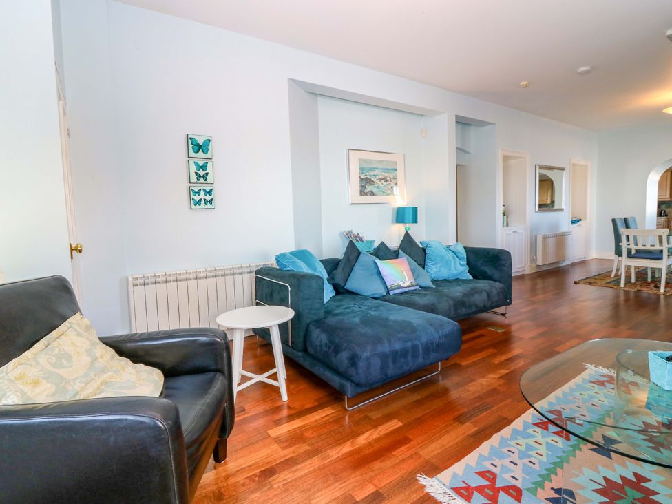 A living room with a sofa and table at The Lighthouse Keepers Cottage, St Abbs