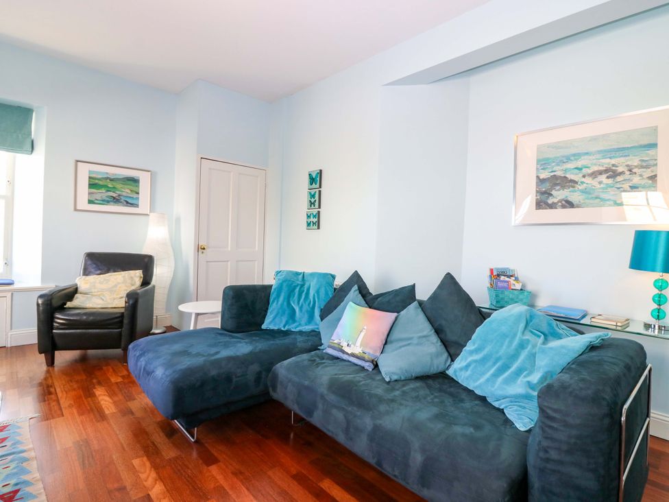 A living room with a sofa and armchair at The Lighthouse Keepers Cottage in St Abbs