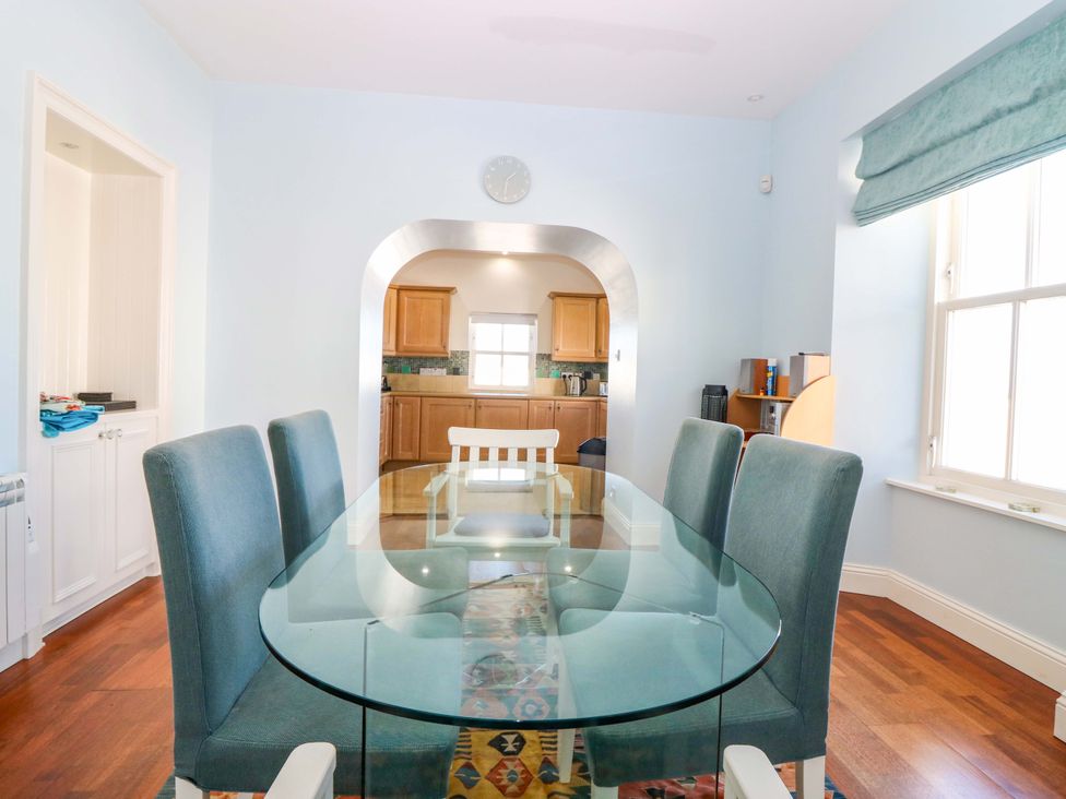 A dining room with a glass table and chairs at The Lighthouse Keepers Cottage St Abbs