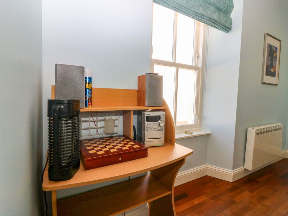 A desk with a chess board and speakers at The Lighthouse Keepers Cottage St Abbs