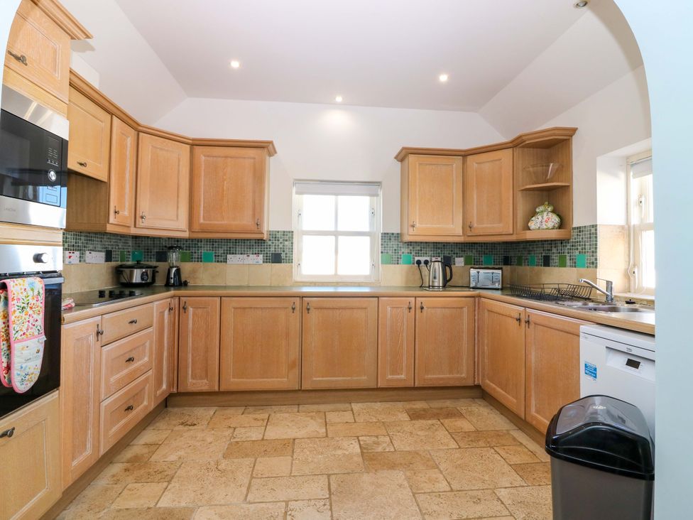 A kitchen with cabinets and appliances at The Lighthouse Keepers Cottage in St Abbs