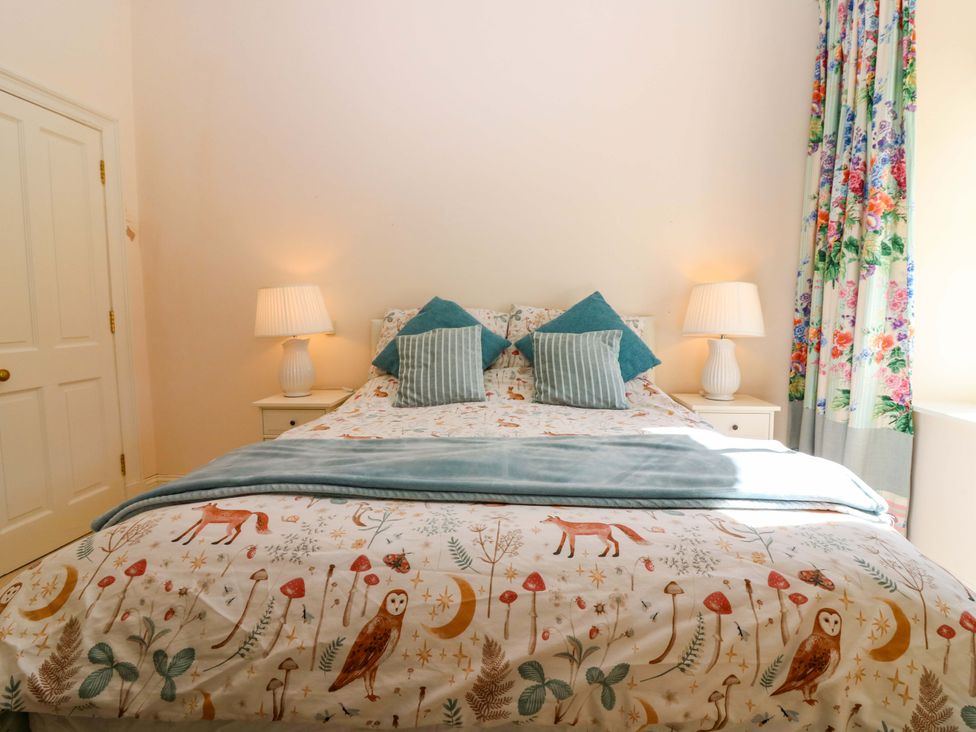 A bedroom with a bed and lamps at The Lighthouse Keepers Cottage St Abbs