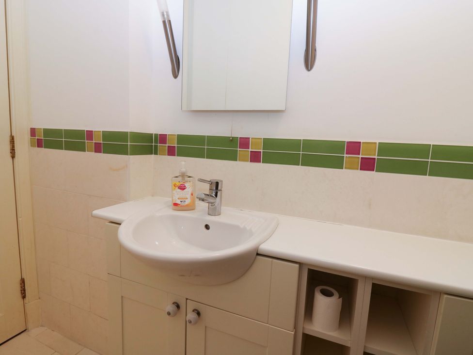 A bathroom with a sink and mirror at The Lighthouse Keepers Cottage St Abbs