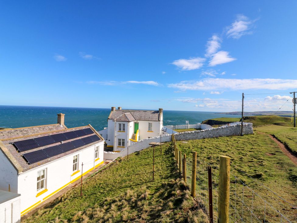 A house with solar panels overlooking the sea at The Lighthouse Keepers Cottage St Abbs