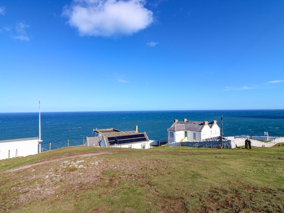A view of houses and the ocean at The Lighthouse Keepers Cottage in St Abbs