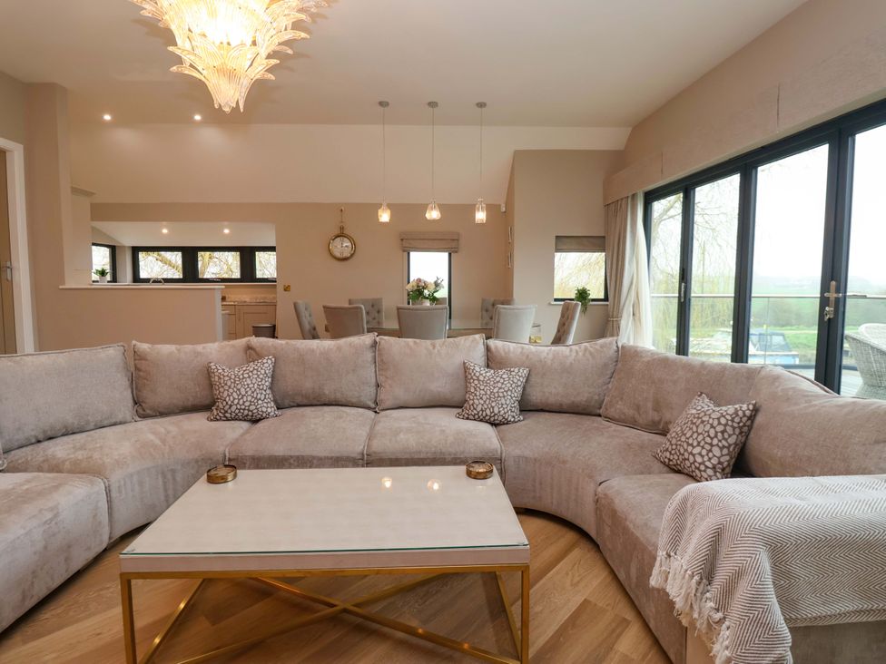 A living room with a sofa and coffee table at Swing Bridge Cottage