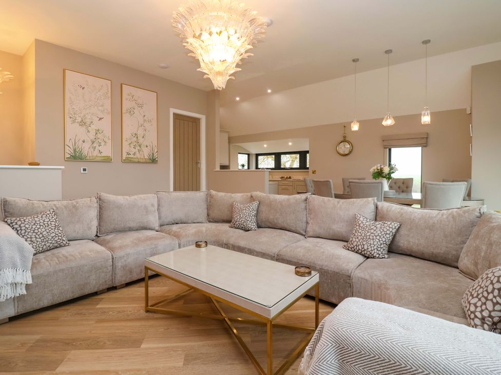 A living room with a sofa and coffee table at Swing Bridge Cottage