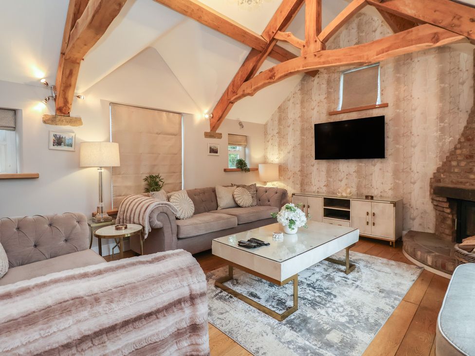 A living room with a sofa and coffee table at Mill Race Cottage Driffield