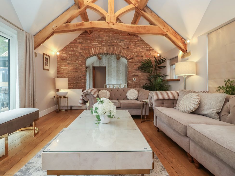 A living room with seating and a coffee table at Mill Race Cottage in Driffield
