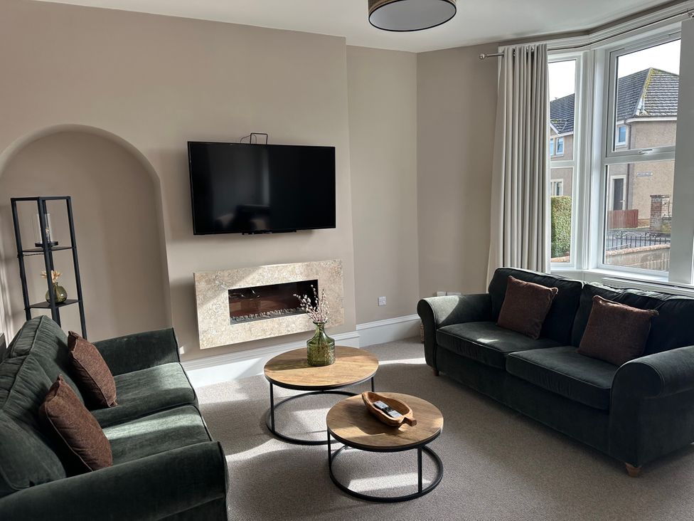 A living room with a television and coffee table at Abbotsford in Kelso