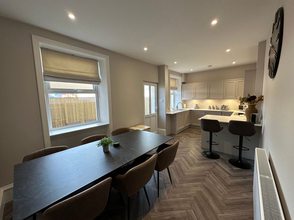 A kitchen with dining area and appliances at Abbotsford in Kelso