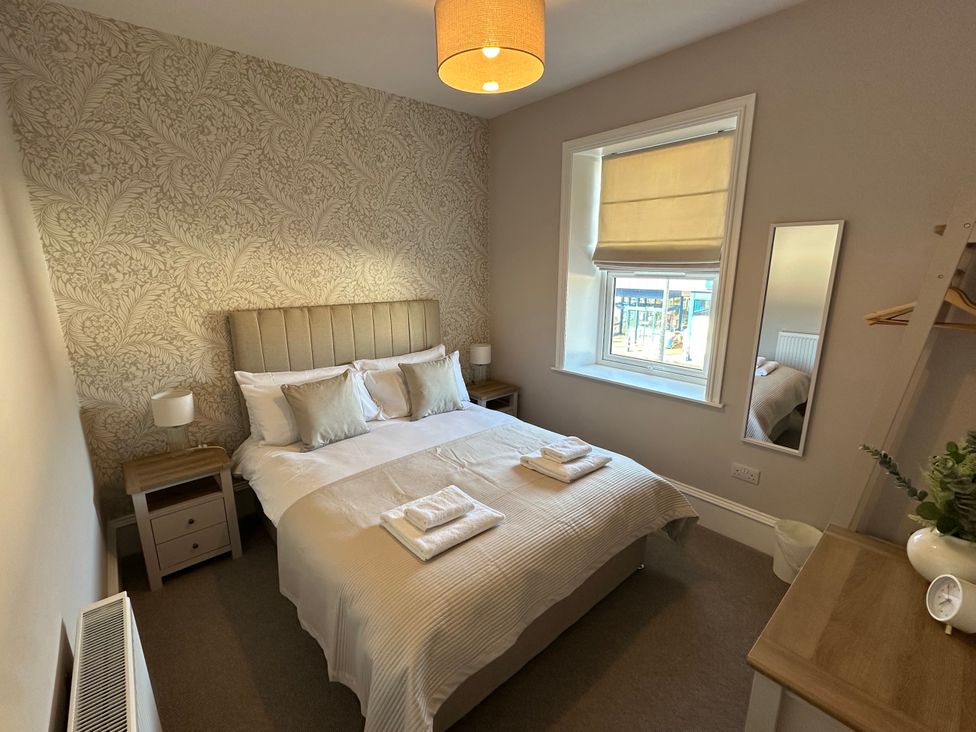 A bedroom with a bed and nightstand at Abbotsford in Kelso