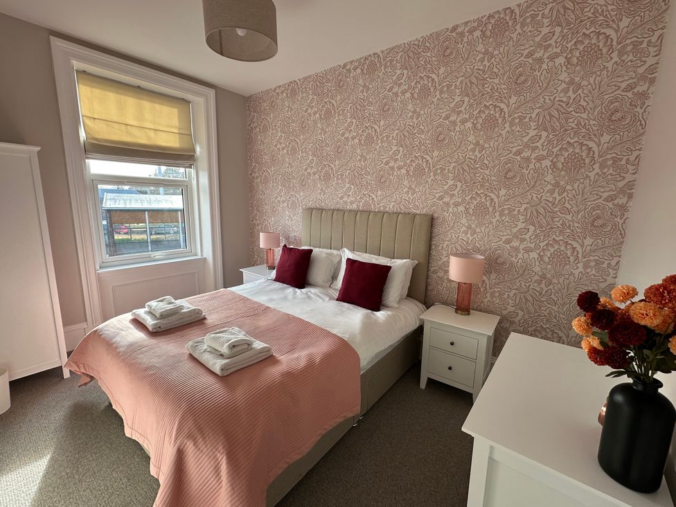A bedroom with a bed and bedside table at Abbotsford in Kelso