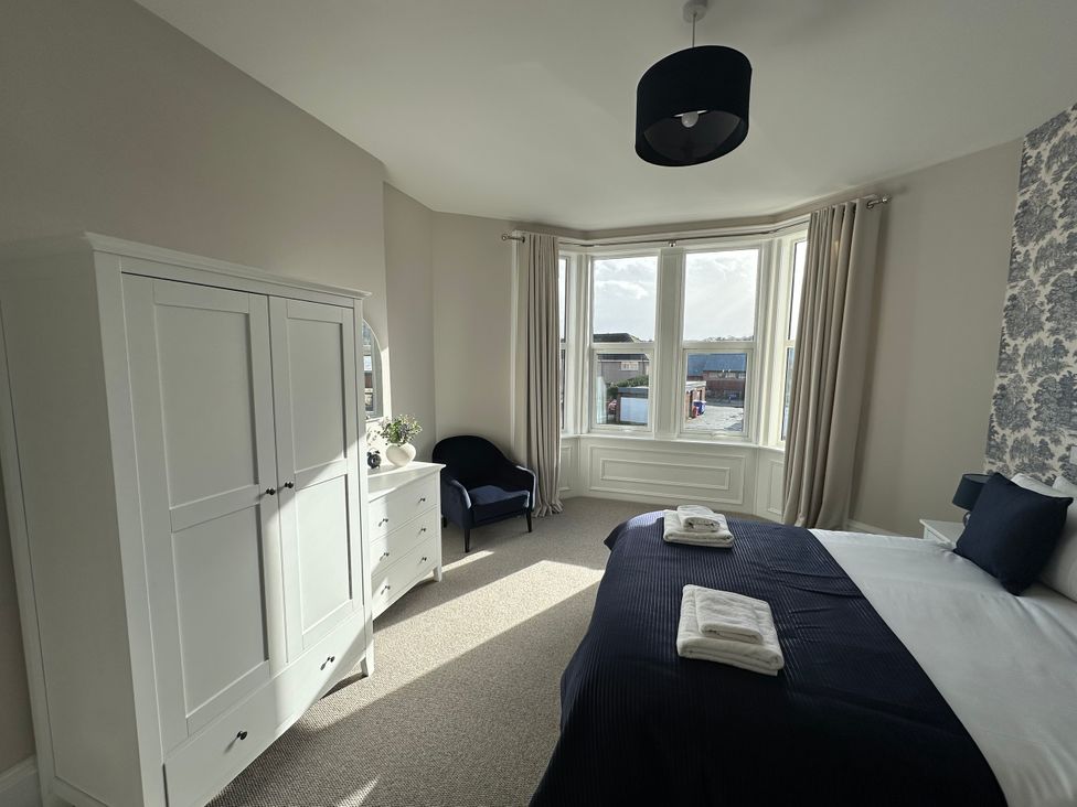 A bedroom with a bed and wardrobe at Abbotsford in Kelso