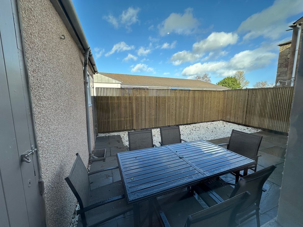 An outdoor seating area with a table and chairs at Abbotsford in Kelso