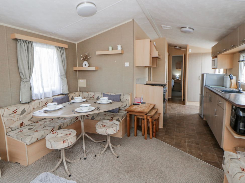 A dining room with a table and seating at Ger Y Mor in New Quay