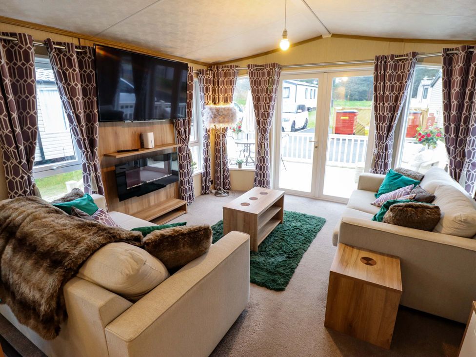 A living room with a sofa and a television at 108 Fox Burrow Hang in Great Yarmouth