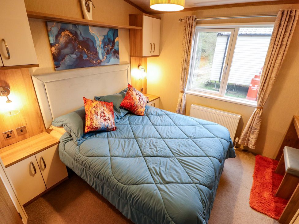 A bedroom with a bed and window at 108 Fox Burrow Hang in Great Yarmouth