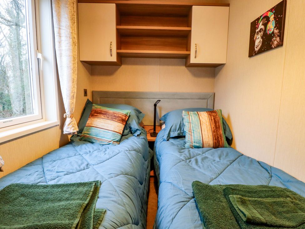 A bedroom with two beds and shelves at 108 Fox Burrow Hang in Great Yarmouth