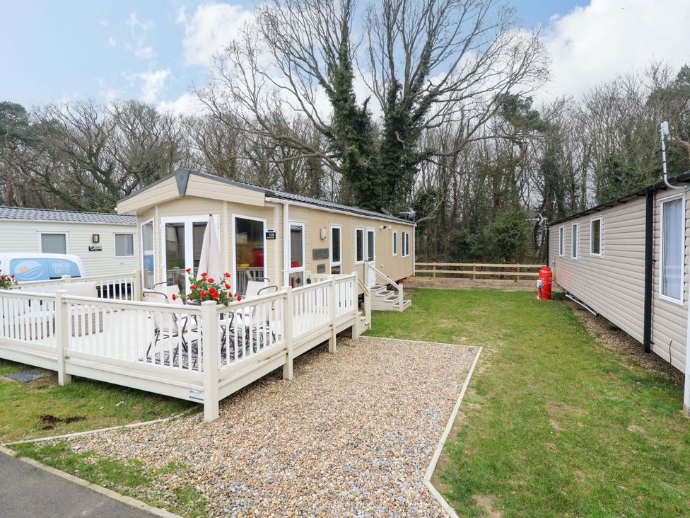 A caravan with decking and outdoor seating at 108 Fox Burrow Hang Great Yarmouth