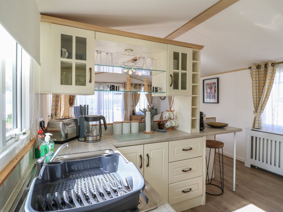 A kitchen with sink, countertop, and appliances at 2 bed Caravan Stowmarket