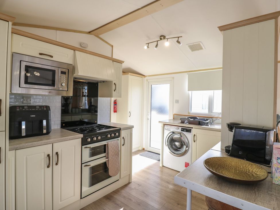 A kitchen with appliances and a sink at 2 bed Caravan Stowmarket