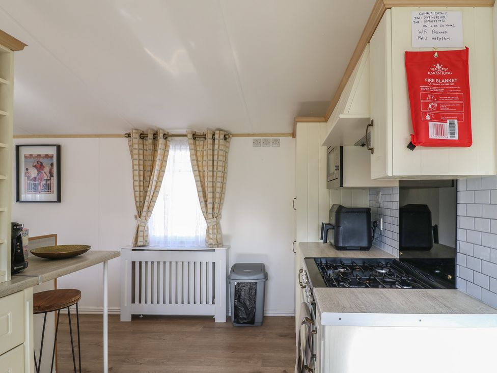 A kitchen with a window and a fire blanket at 2 bed Caravan Stowmarket