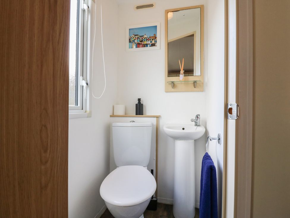 A bathroom with a toilet and sink at 2 bed Caravan in Stowmarket