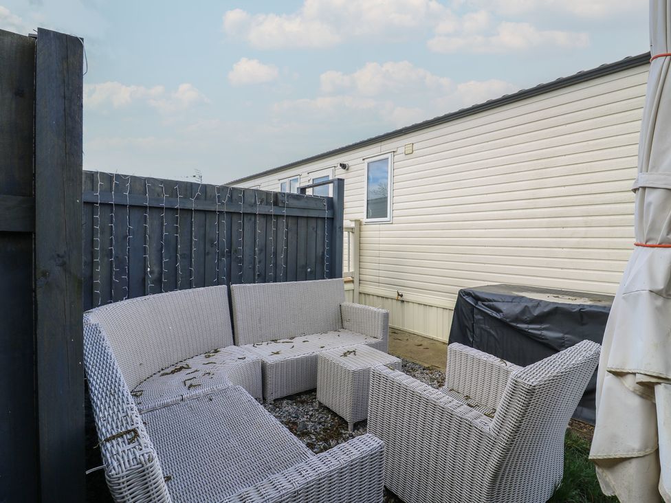 An outdoor seating area with a sofa and chairs at 2 bed Caravan Stowmarket