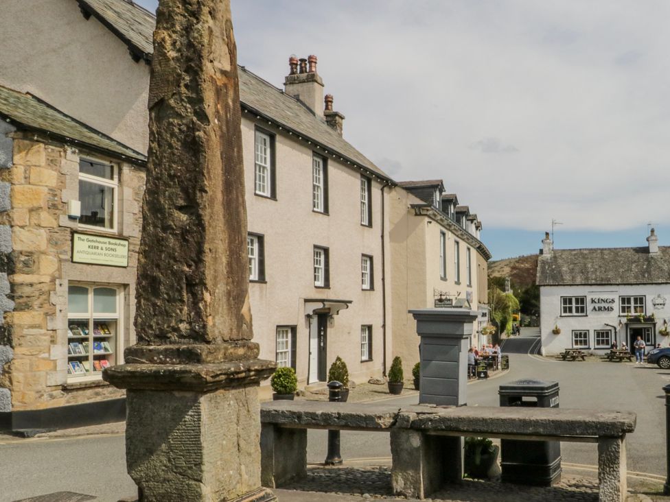 A street scene with buildings and a stone pillar at Linden Lea Grange-Over-Sands