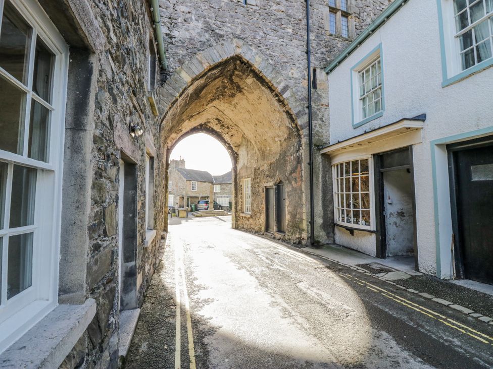 An archway leading to a street with buildings in Grange-Over-Sands