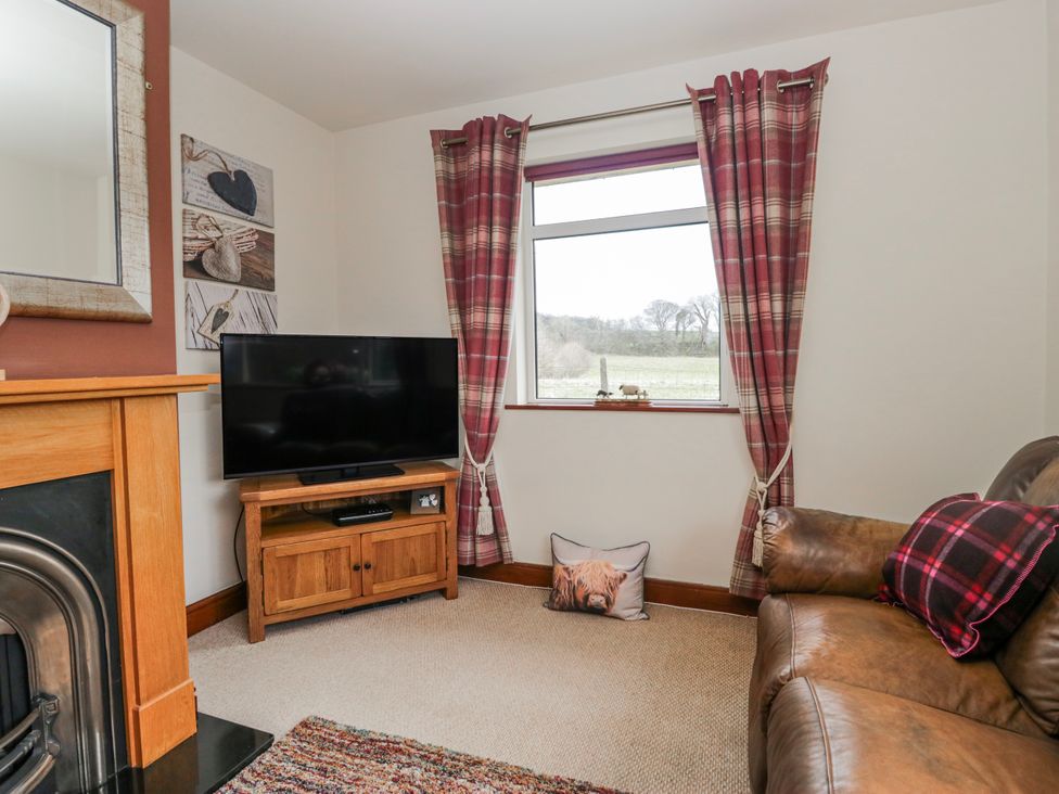 A living room with a television and sofa at Linden Lea Field Broughton near Cartmel