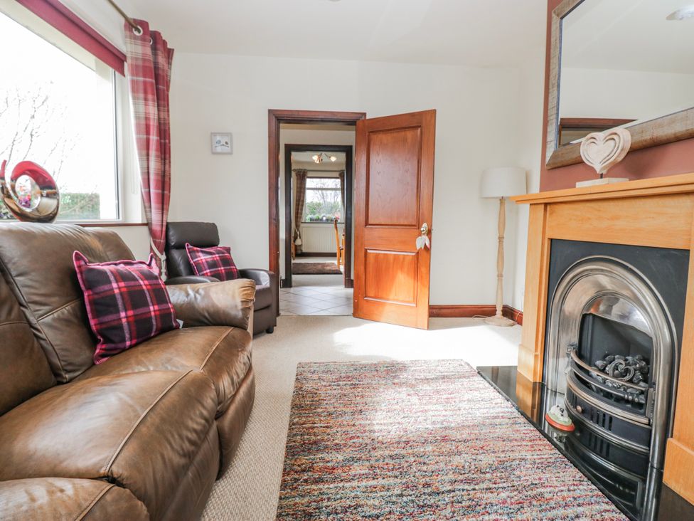 A living room with a sofa and fireplace at Linden Lea Field Broughton near Cartmel