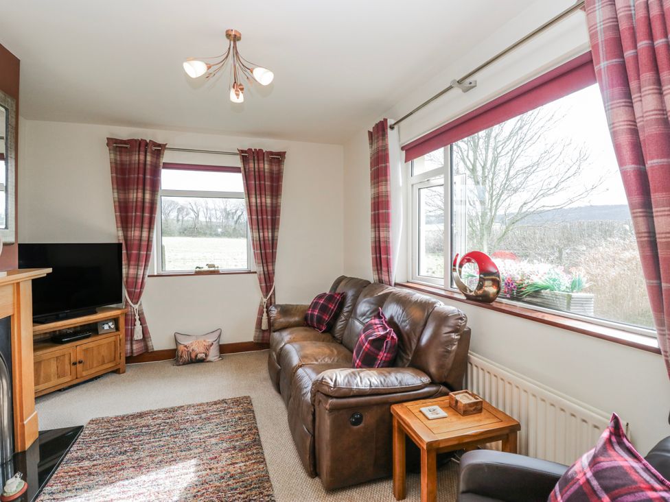 A living room with a sofa and television at Linden Lea Field Broughton near Cartmel