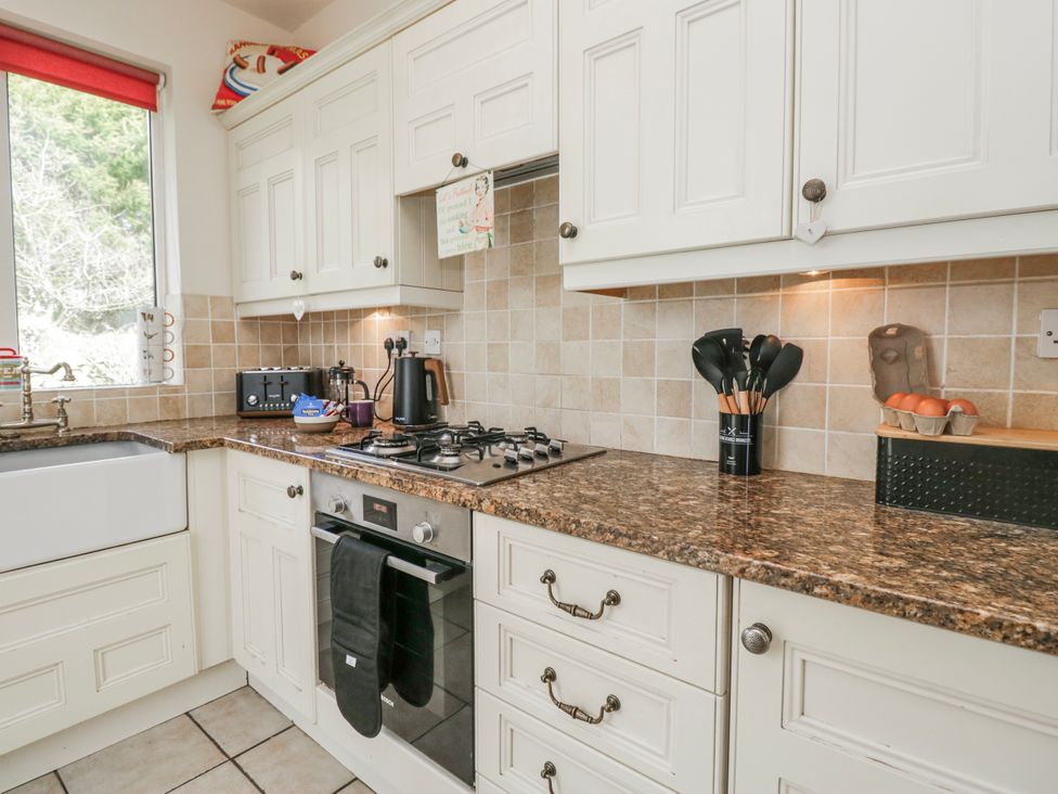 A kitchen with a sink and gas stove at Linden Lea Field Broughton near Cartmel
