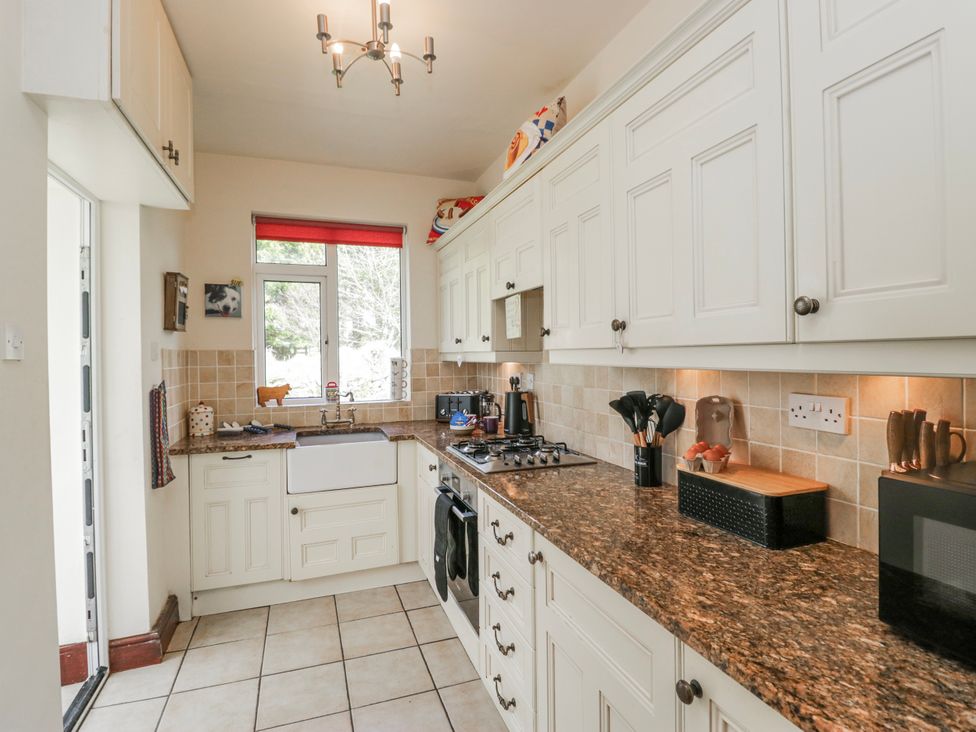 A kitchen with a sink and stove at Linden Lea Field Broughton near Cartmel
