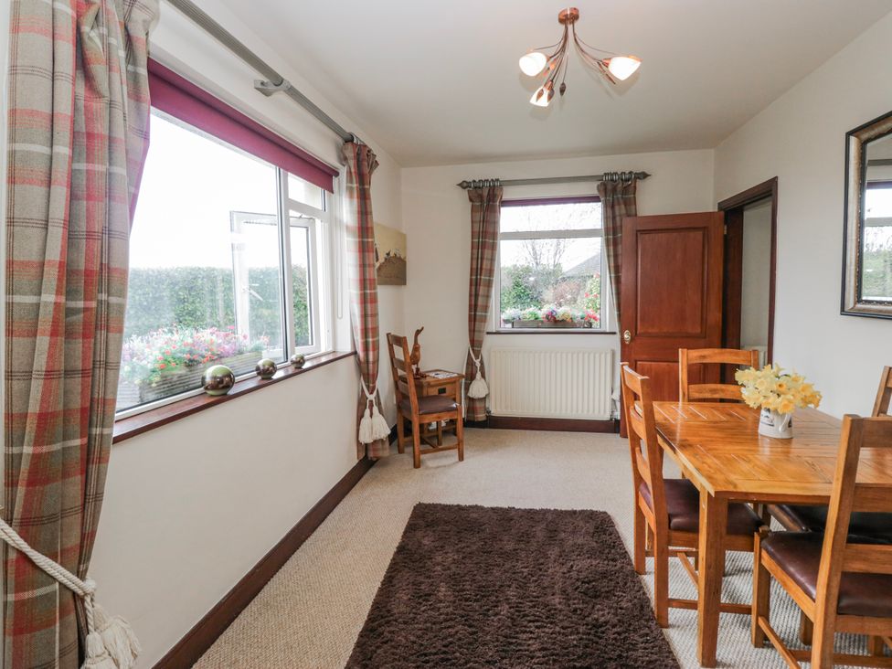 A dining room with a table and chairs at Linden Lea Field Broughton near Cartmel