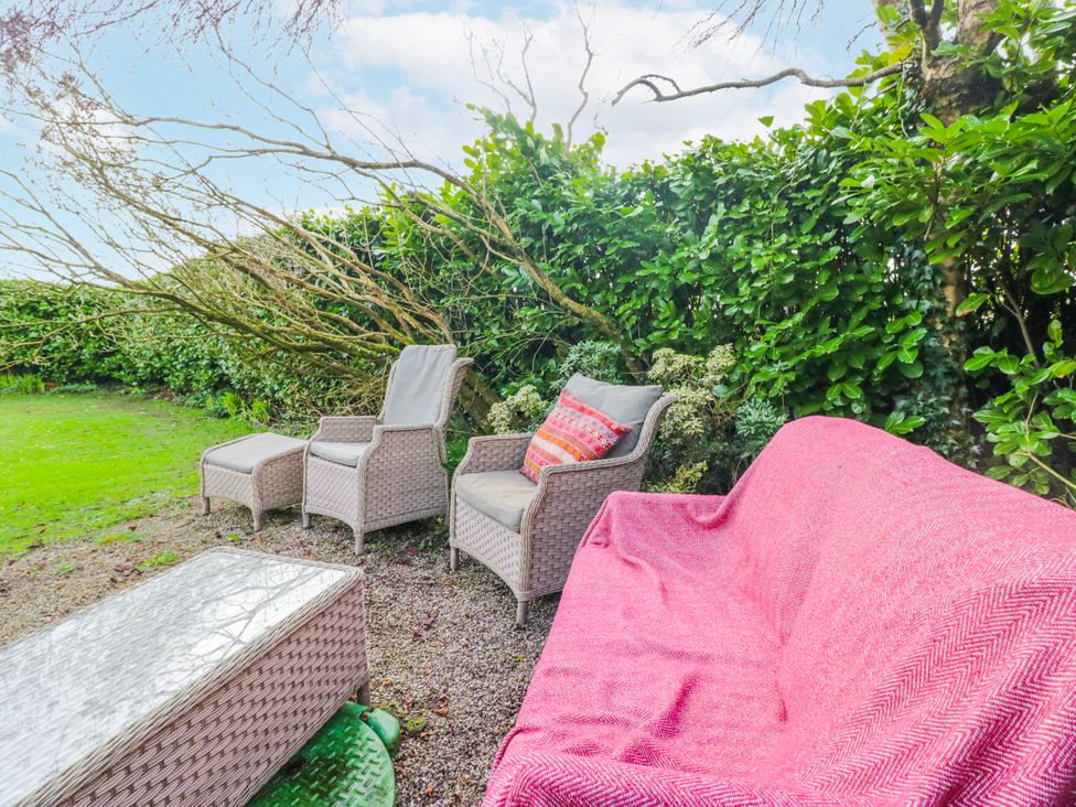 A garden seating area with a sofa and chairs at Linden Lea Field Broughton near Cartmel