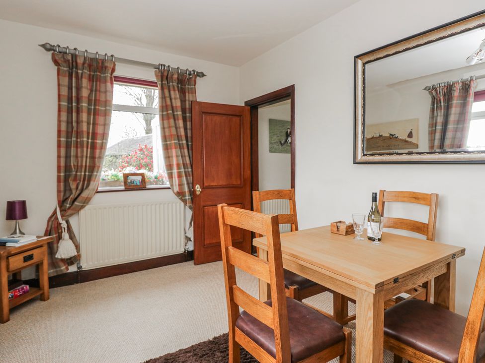 A dining room with a table and chairs at Linden Lea Field Broughton near Cartmel