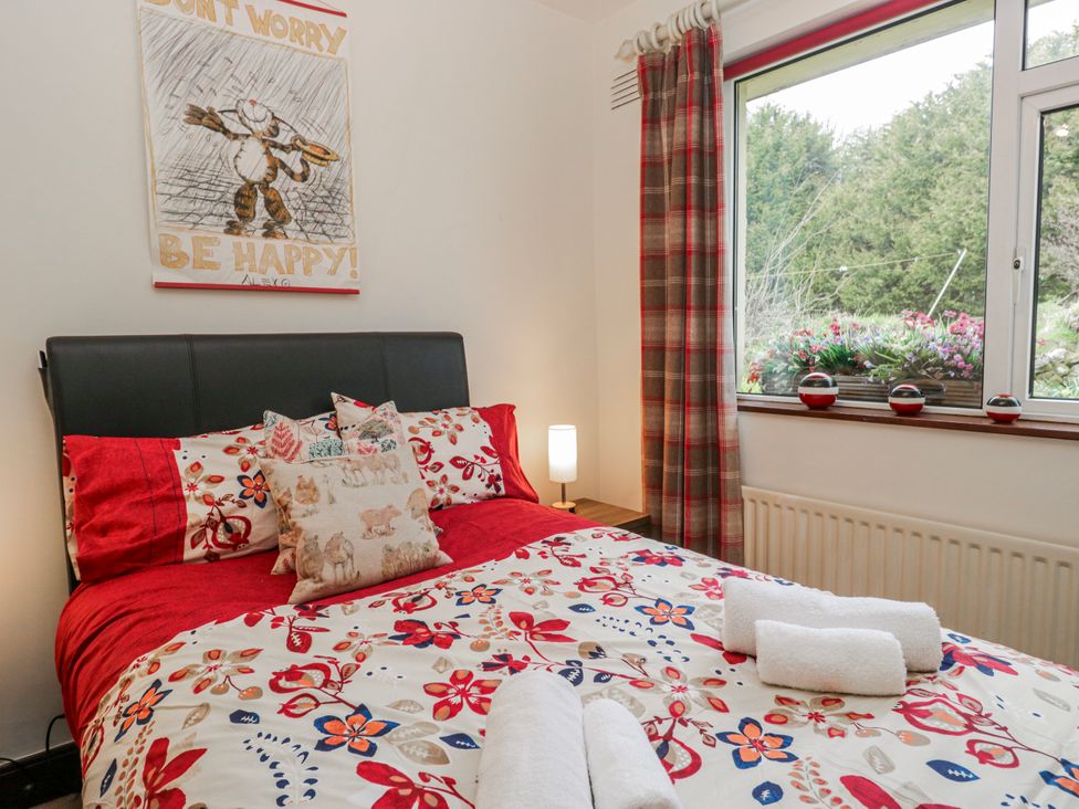 A bedroom with a bed, pillows, and a window at Linden Lea Field Broughton near Cartmel