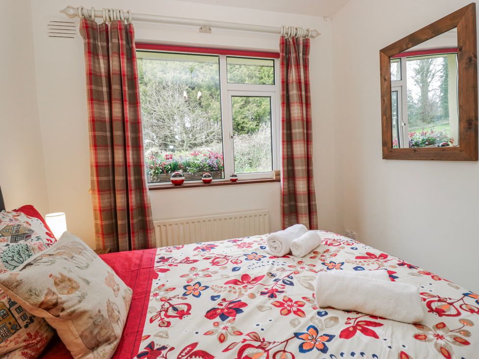 A bedroom with a bed and window at Linden Lea Field Broughton near Cartmel