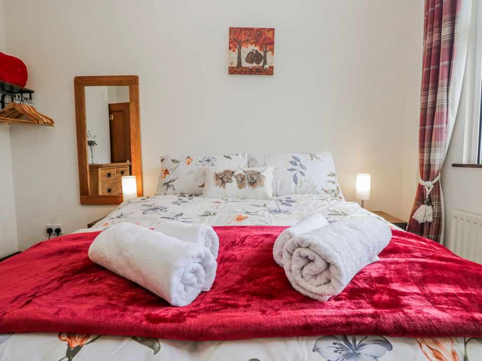 A bedroom with a bed and towels at Linden Lea Field Broughton near Cartmel