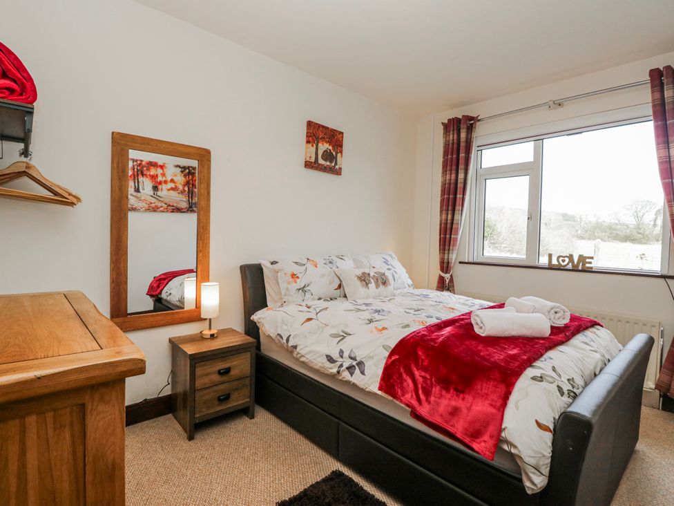 A bedroom with a bed and nightstand at Linden Lea Field Broughton near Cartmel
