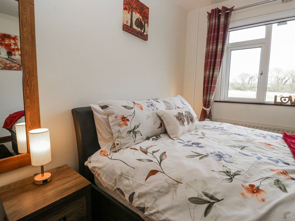 A bedroom with a bed and window at Linden Lea Field Broughton near Cartmel