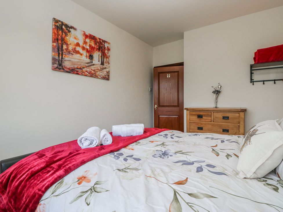 A bedroom with a bed and towels on it at Linden Lea Field Broughton near Cartmel