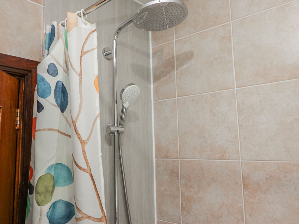 A shower with a curtain and handheld shower in Linden Lea Field Broughton near Cartmel