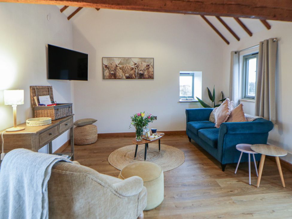 A living room with a television and seating area at Wyn's Barn Nantmel near Rhayader