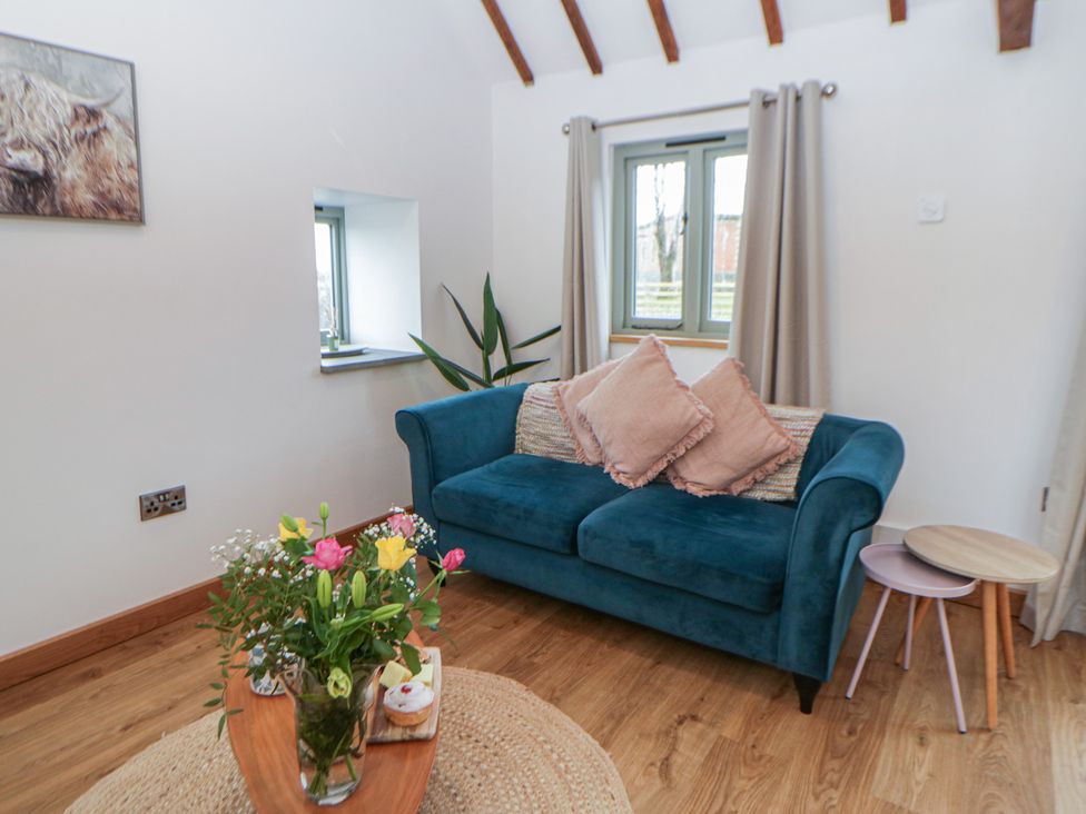 A living room with a sofa and coffee table at Wyn's Barn Nantmel near Rhayader