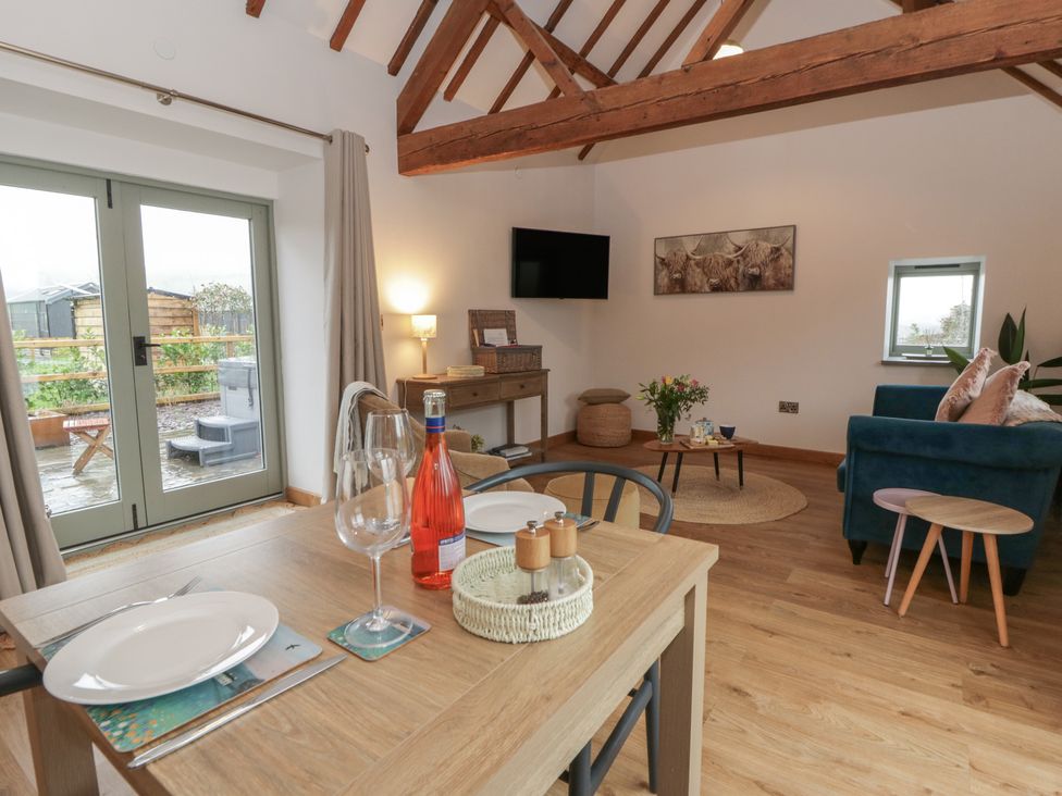 A living room with a table set for dining at Wyn's Barn Nantmel near Rhayader