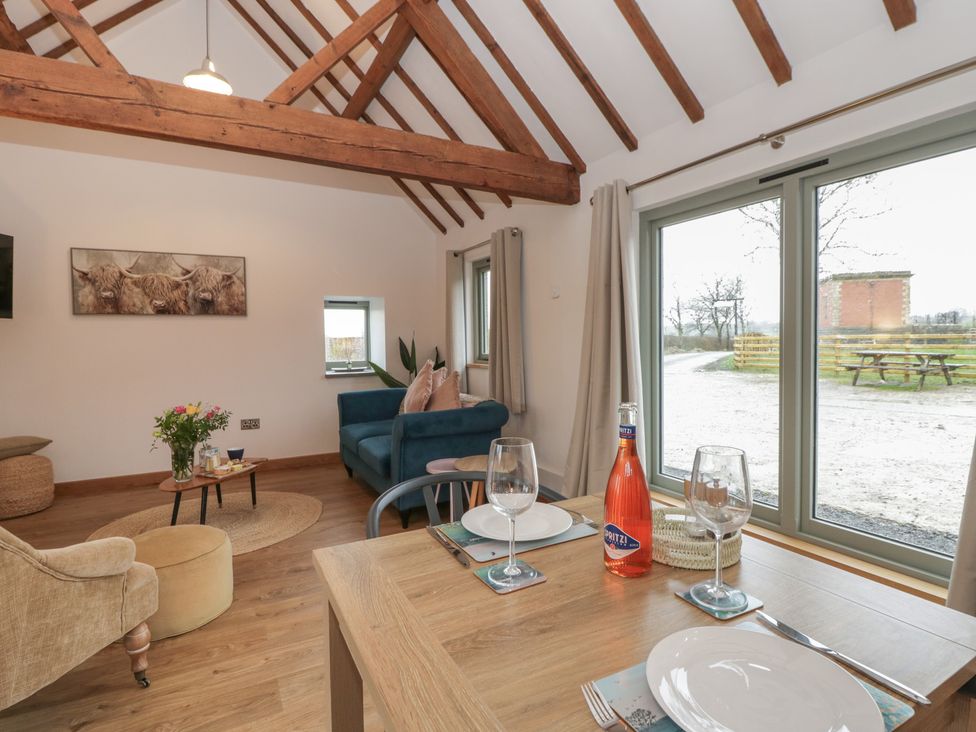 A living room with a table and sofa at Wyn's Barn Nantmel near Rhayader